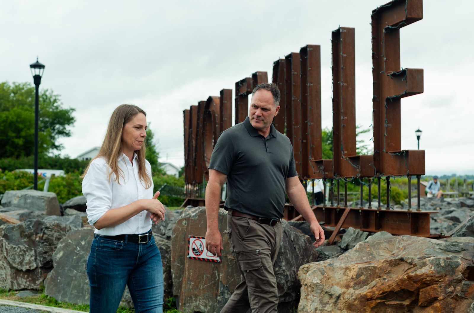 Becky Druhan walking and talking with a community member